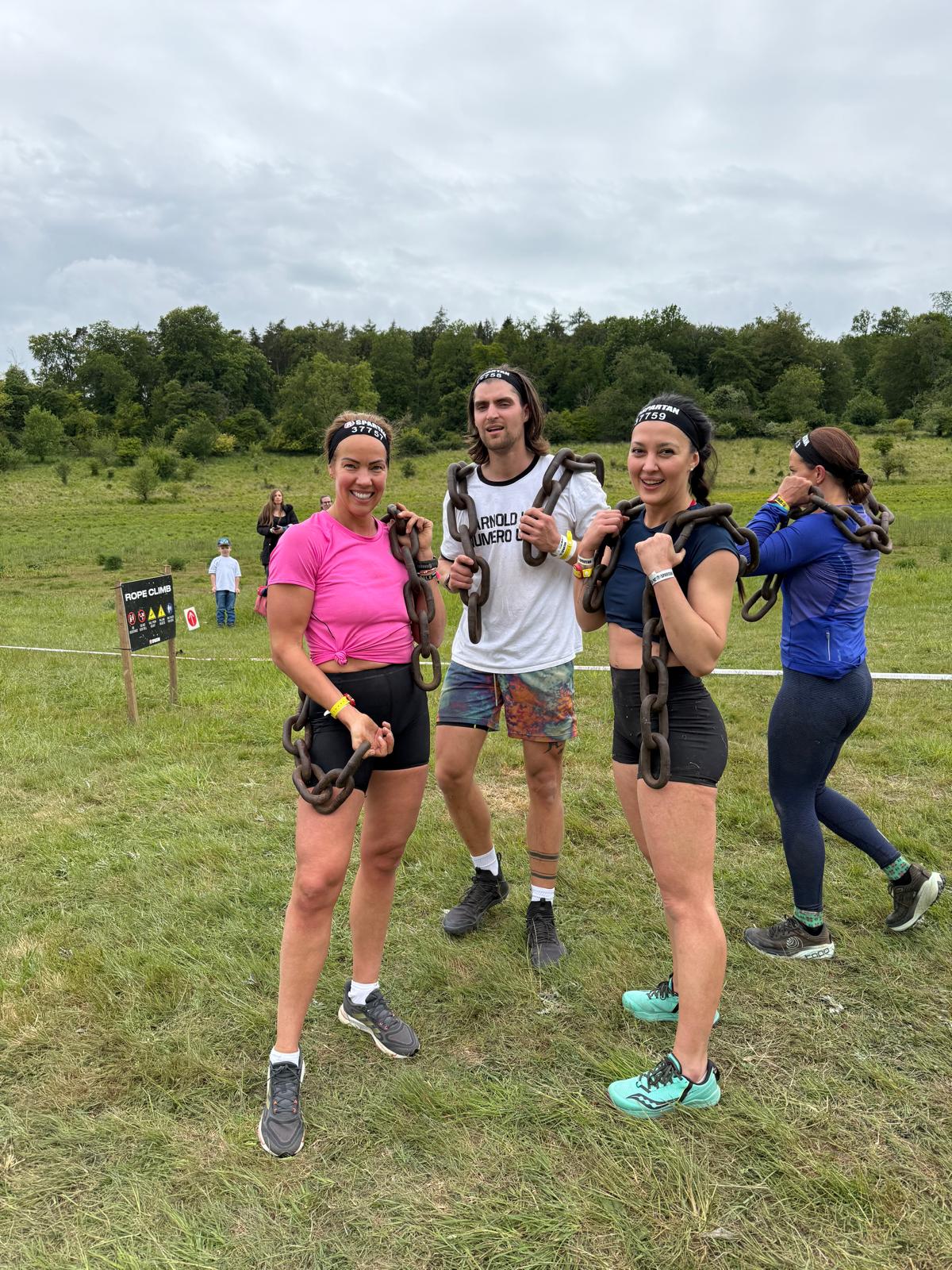 Alla and teammates carrying chains during a Spartan race
