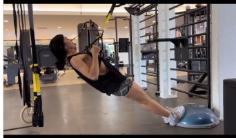 Alla performing a TRX suspension exercise in the studio